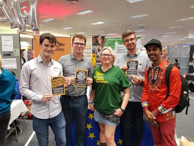 Image courtesy of greenlibdems.org.uk Mary Page and some young Green Lib Dems at the stall at Brighton 2018
