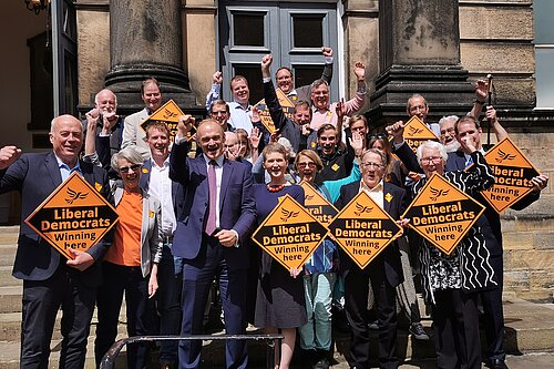 Tom Gordon amongst other liberal democrats including Ed Davey, all holding LD signs