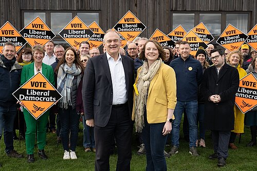 Cheney and Ed Davey in front of a crowd of Lib Dems