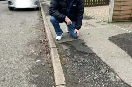 Andy Carr with damaged footpath awaiting repair