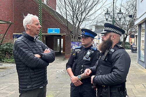 John speaking with police