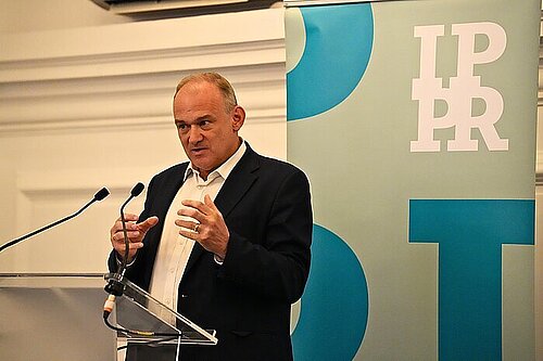 Ed Davey presenting plans to half energy bills
