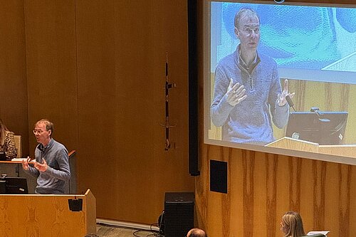 Mark at the lectern in the Council chamber