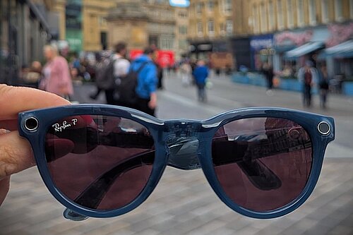 Close up picture of pair of sunglasses with Newcastle City Centre and Grey's Monument in background