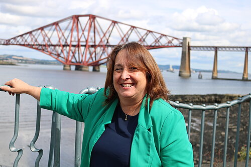 Christine Jardine standing in front of the Forth Rail Bridge