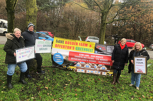 MP Lisa Smart standing with green belt protesters and their signs