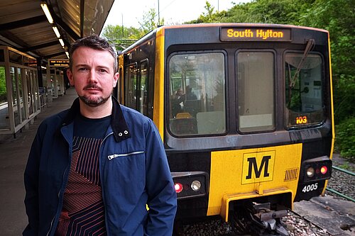Martin Haswell staanding in front of a Metro carriage