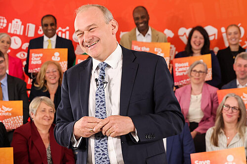 Ed Davey with a child on his shoulders