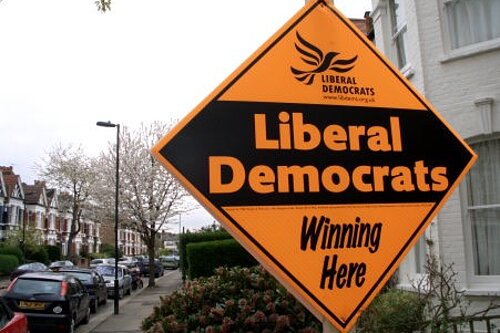 Photo of a stakeboard outside a house. Stakeboard reads "Liberal Democrats winning here"
