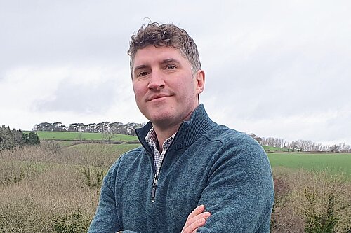 Lib Dem Candidate Edward Morello smiling in a rural part of West Dorset.