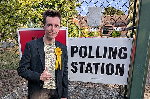 Nathan Hunt by a polling station sign