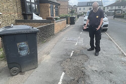 Liberal Democrat campaigner Alan Jones reporting potholes on Warwick Road