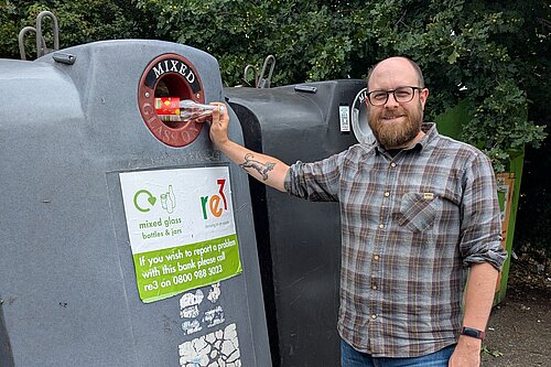 Councillor James Moore with glass recycling.