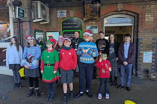 Alison singing carols at station with Woodlands Meed students